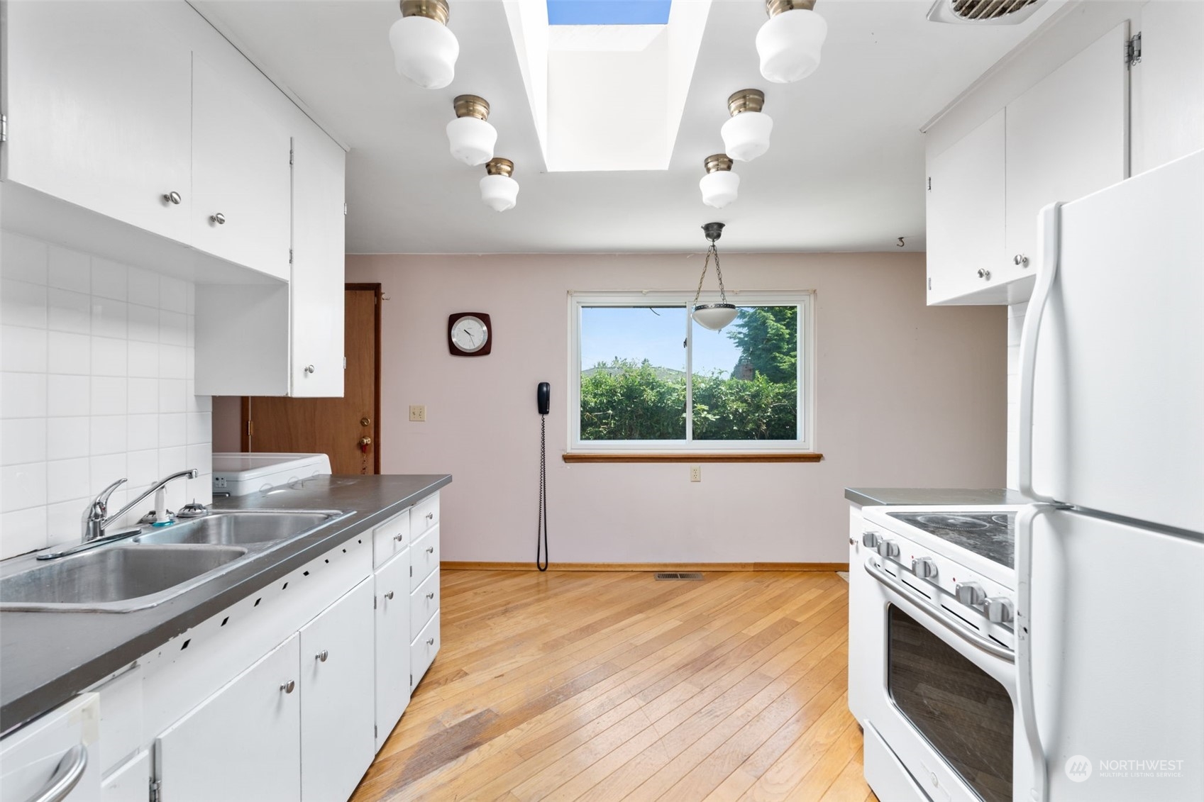 7634 South 112th Street Seattle, WA 98178 - Photo 4 of 26 a kitchen with a stove a sink and a refrigerator