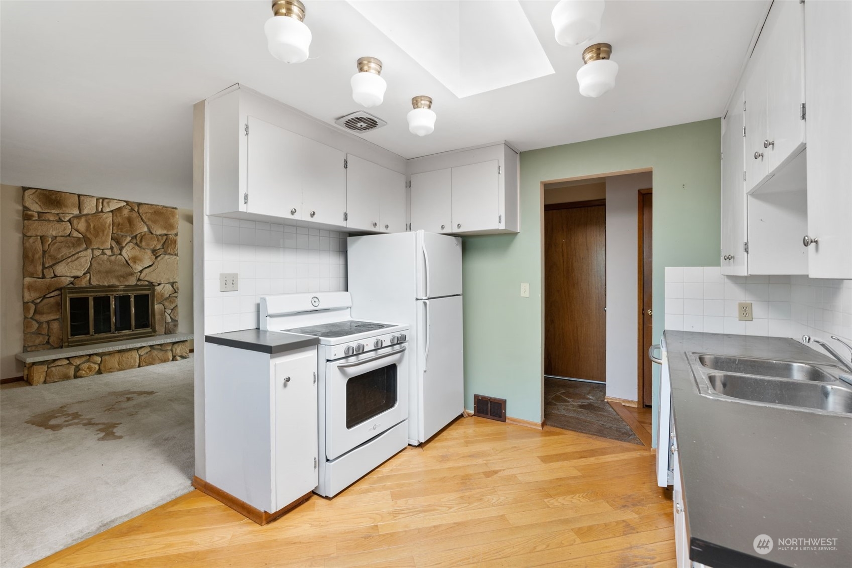 7634 South 112th Street Seattle, WA 98178 - Photo 9 of 26 a kitchen with stainless steel appliances granite countertop a stove and a refrigerator