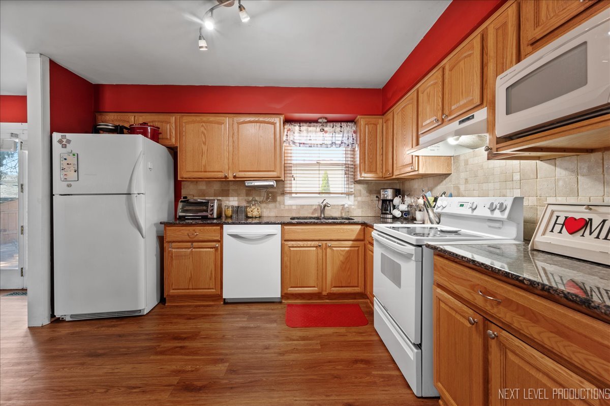 1701 South Tyler Road St. Charles, IL 60174 - Photo 9 of 24 a kitchen with a refrigerator sink and cabinets