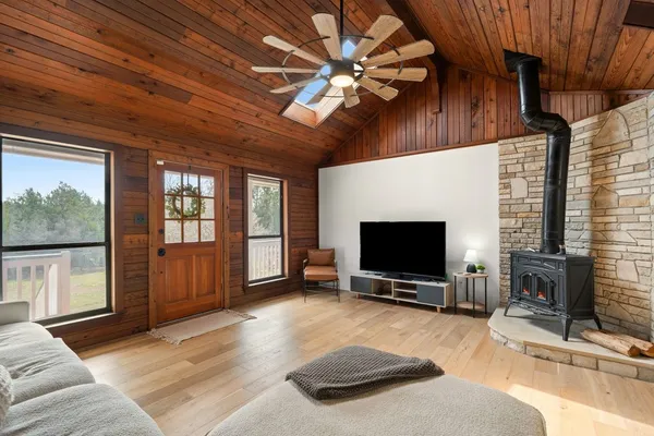 a living room with a flat screen tv and a fireplace