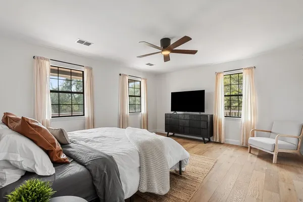 a bedroom with a bed and a flat screen tv