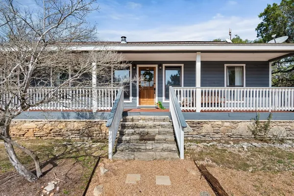 a front view of a house with iron fence