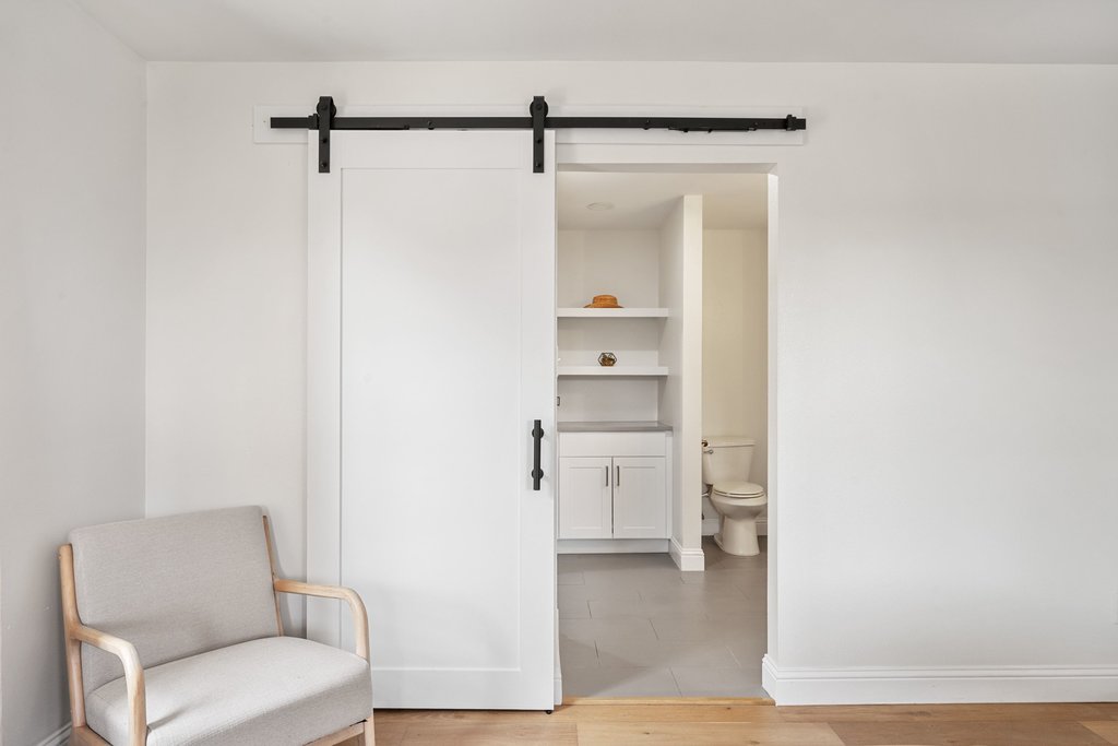 201 Raincloud Road Wimberley, TX 78676 - Photo 21 of 40 Sitting room with a barn door and light wood-type flooring