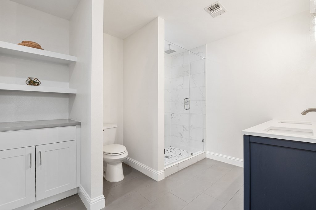 201 Raincloud Road Wimberley, TX 78676 - Photo 24 of 40 Bathroom with vanity, a marble finish shower, and light tile patterned flooring