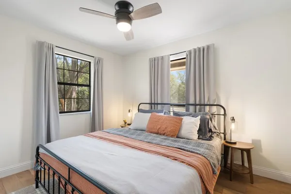 a bedroom with a bed and a window