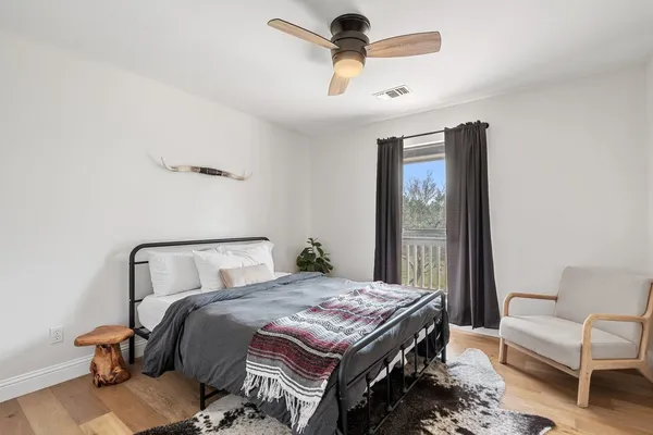 a bedroom with a bed a couch and a window