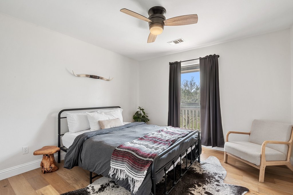 201 Raincloud Road Wimberley, TX 78676 - Photo 26 of 40 Bedroom featuring light wood-type flooring and a ceiling fan