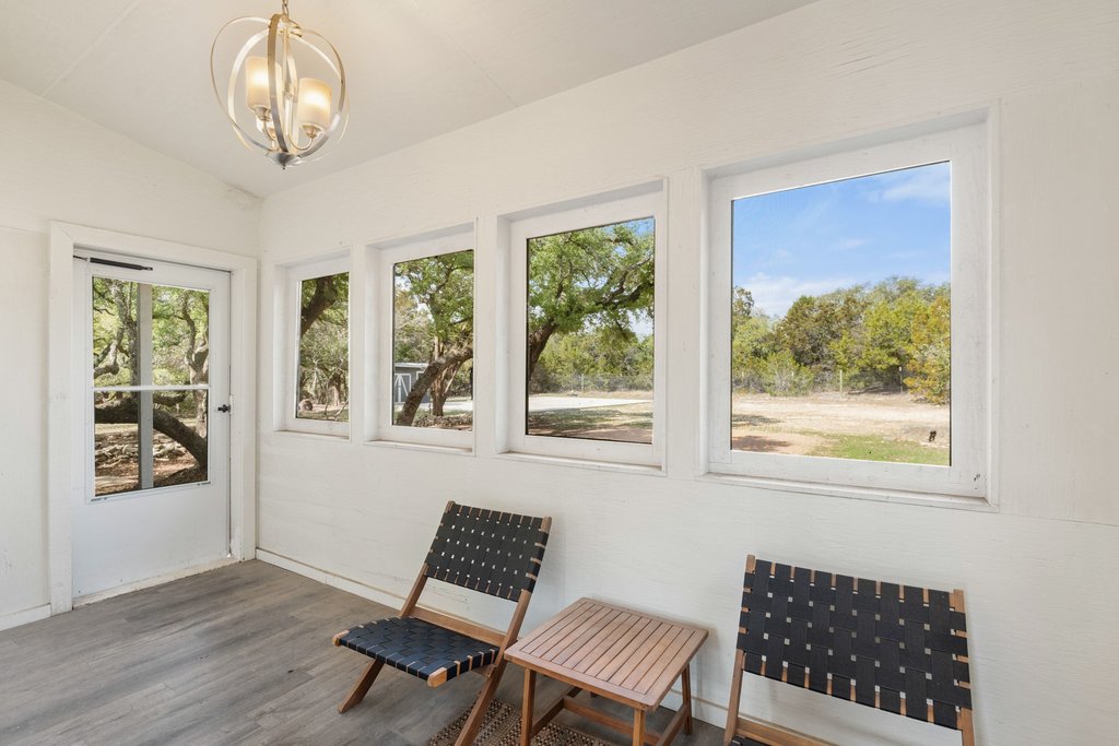 201 Raincloud Road Wimberley, TX 78676 - Photo 28 of 40 Sunroom / solarium with wood finished floors and hanging lights