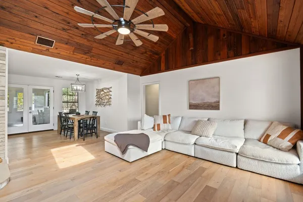 a living room with furniture and wooden floor
