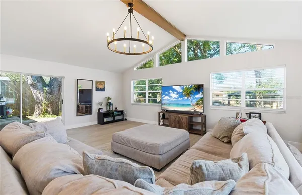 a living room with furniture and a chandelier