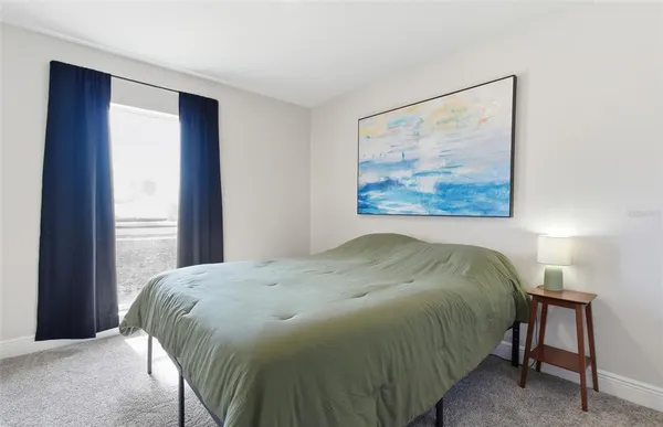 a bed sitting in a bedroom next to a window