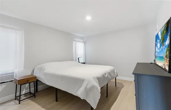 a bedroom with a bed and a desk