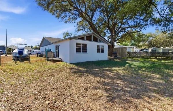 a white house that has a tree in front of it