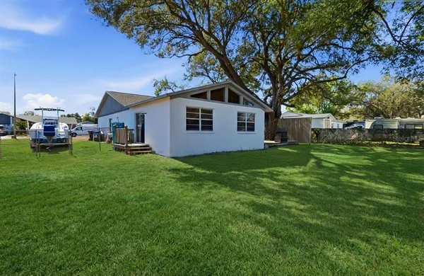 a front view of house with yard and green space