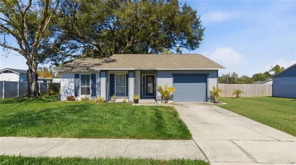 front view of a brick house with a yard