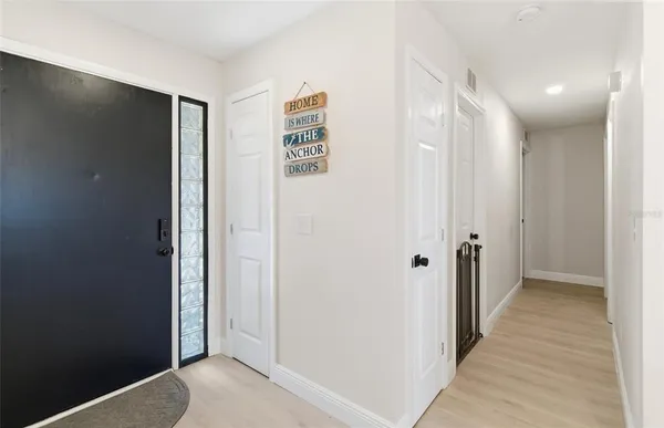a view of a hallway with wooden floor