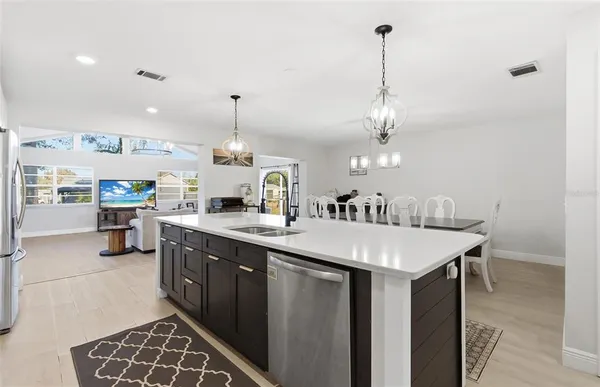 a large kitchen with a table and chairs