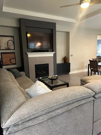 a living room with fireplace furniture and a flat screen tv