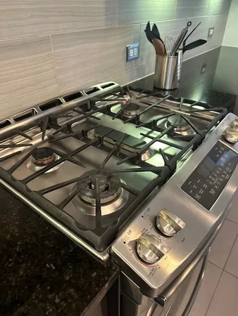 a stove top oven sitting inside of a kitchen
