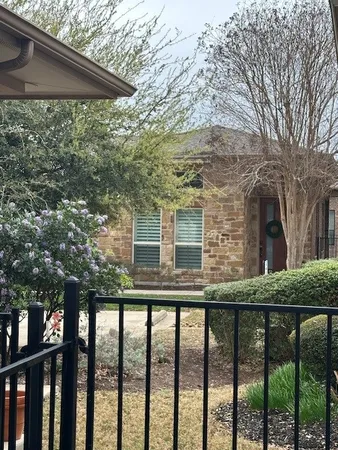 a side view of a house with a tree