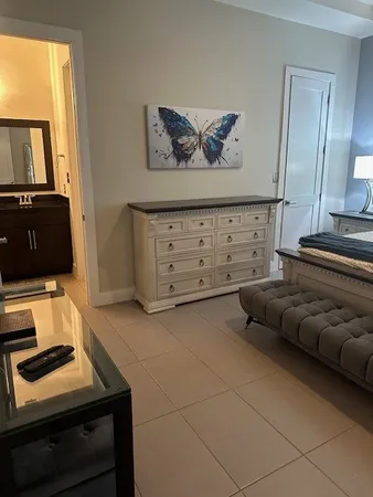 a bedroom with a bed and a television