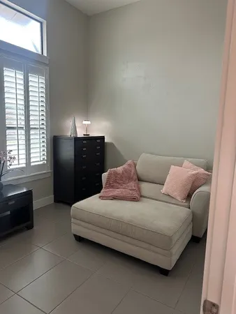 a bedroom with a bed and window