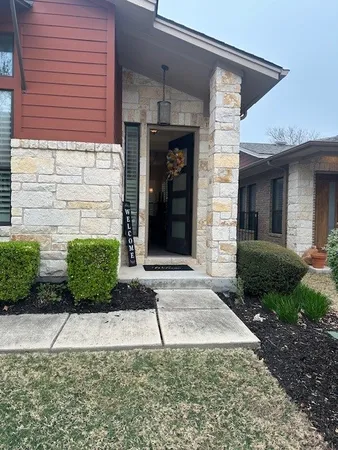 a view of a brick house with a yard