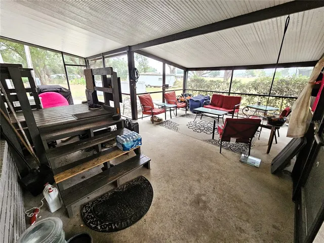 a room with furniture gym equipment and a large window