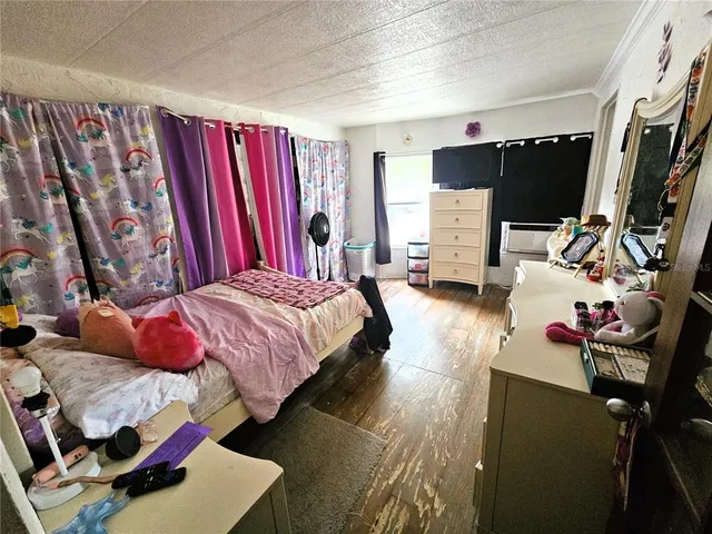a bedroom with a bed furniture and a flat screen tv