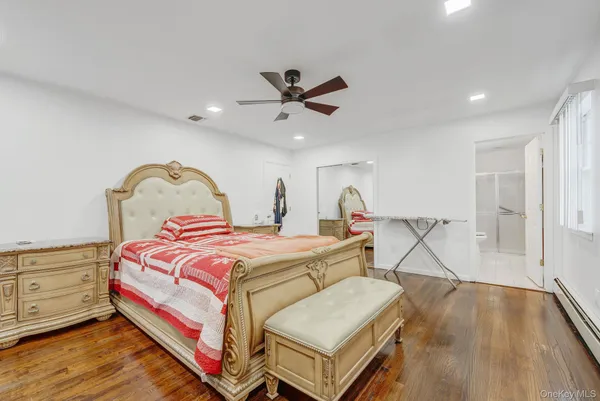 a bedroom with bed and a chandelier