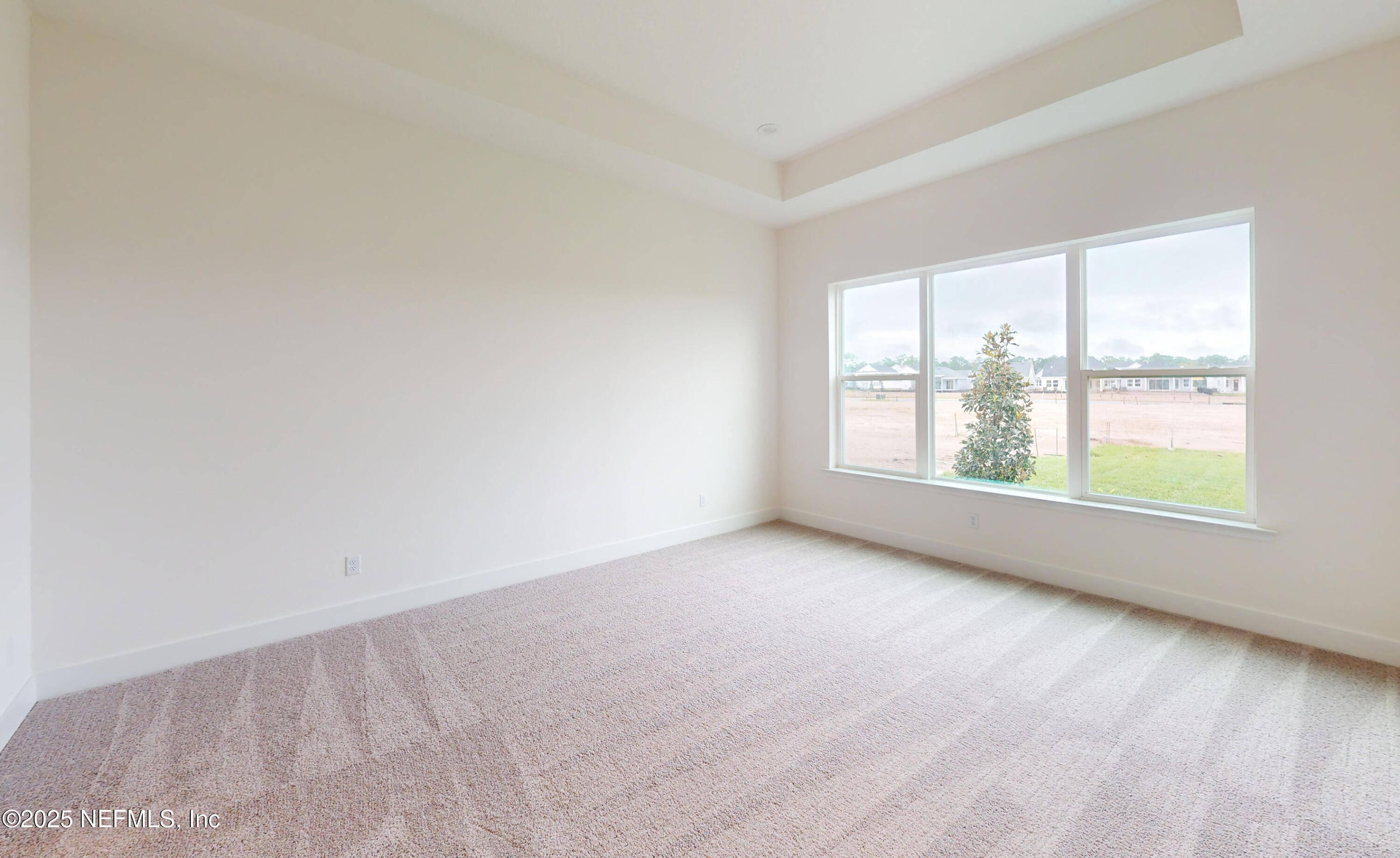 5541 Rainbarrel Road Jacksonville, FL 32224 - Photo 12 of 23 an empty room with windows
