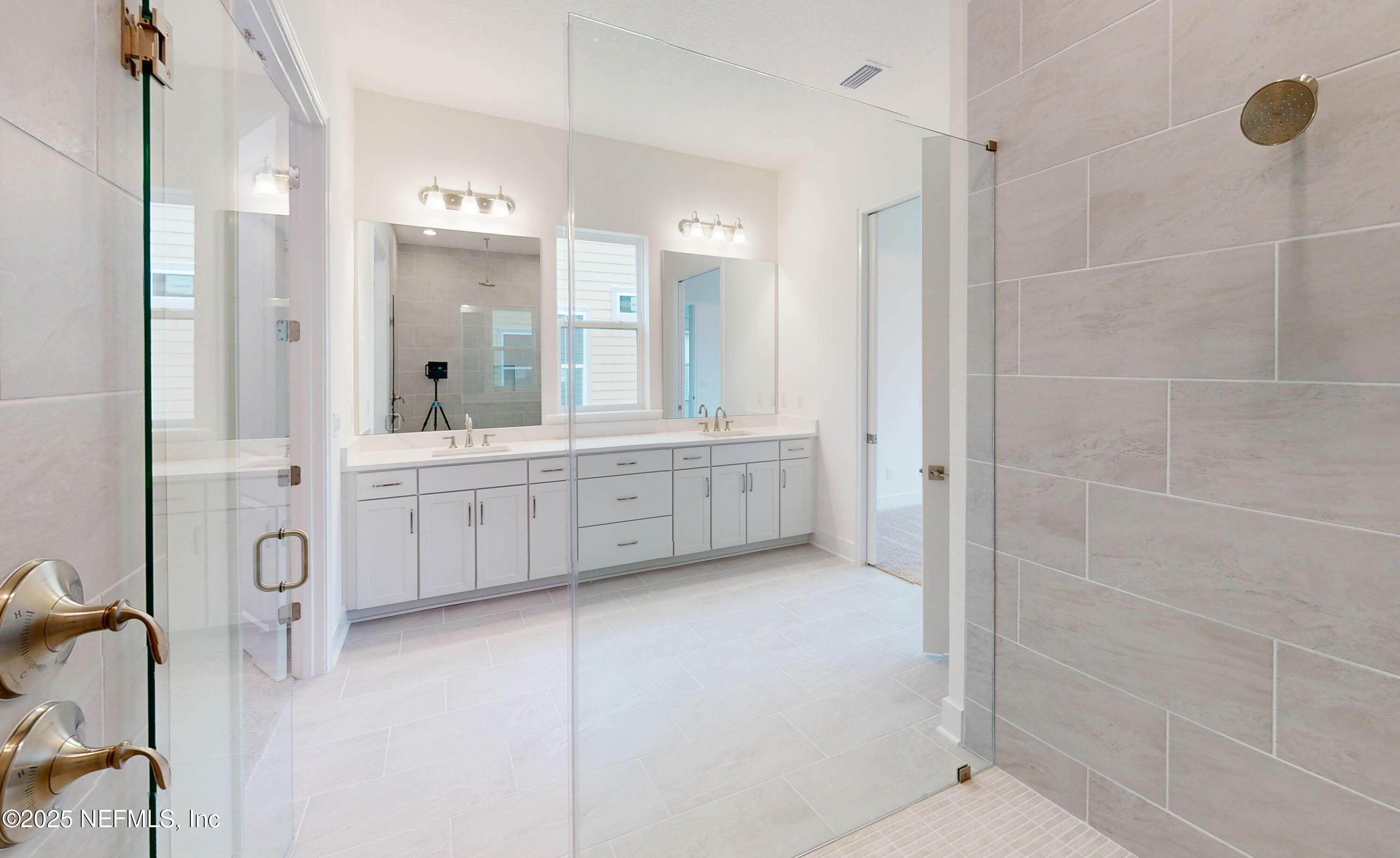 5541 Rainbarrel Road Jacksonville, FL 32224 - Photo 13 of 23 a bathroom with a double vanity sink a mirror and a shower