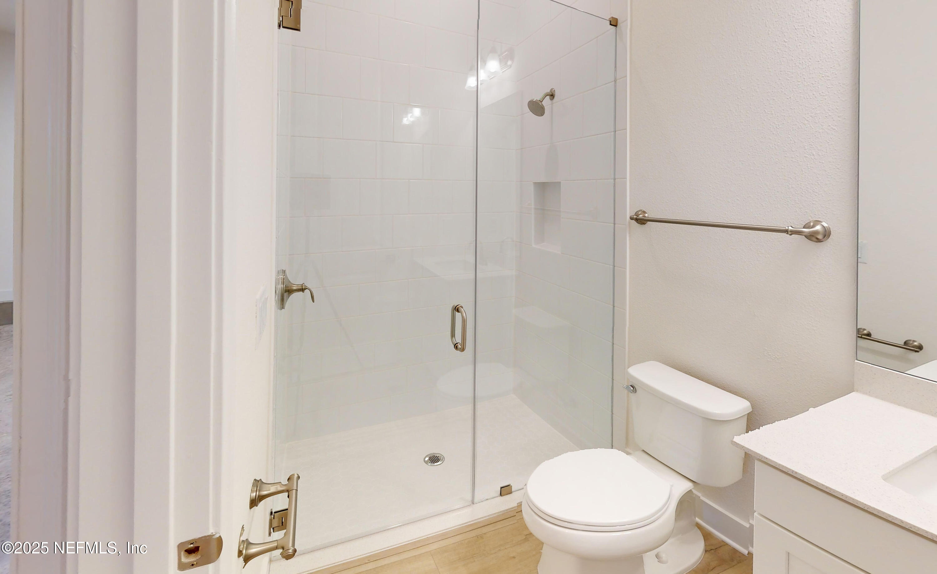 5541 Rainbarrel Road Jacksonville, FL 32224 - Photo 17 of 23 a white toilet sitting next to a bathroom sink