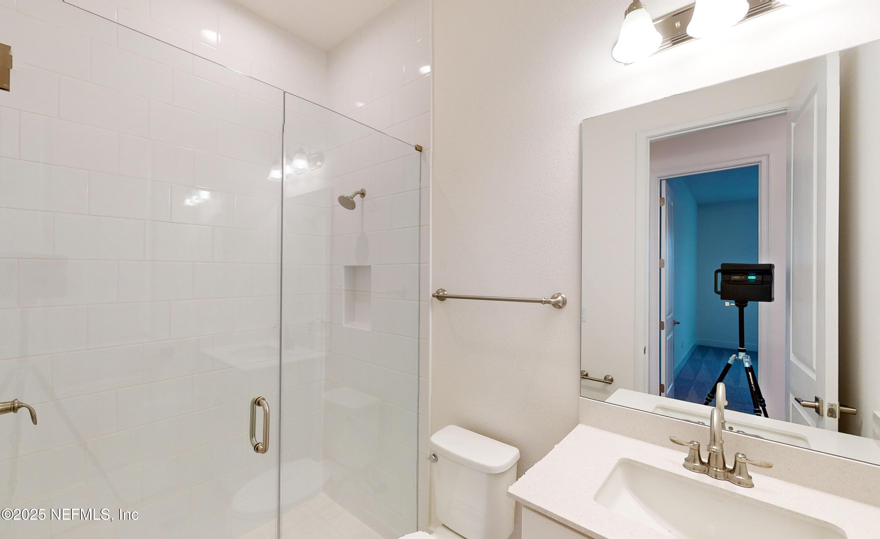 5541 Rainbarrel Road Jacksonville, FL 32224 - Photo 20 of 23 a bathroom with a sink shower and a mirror