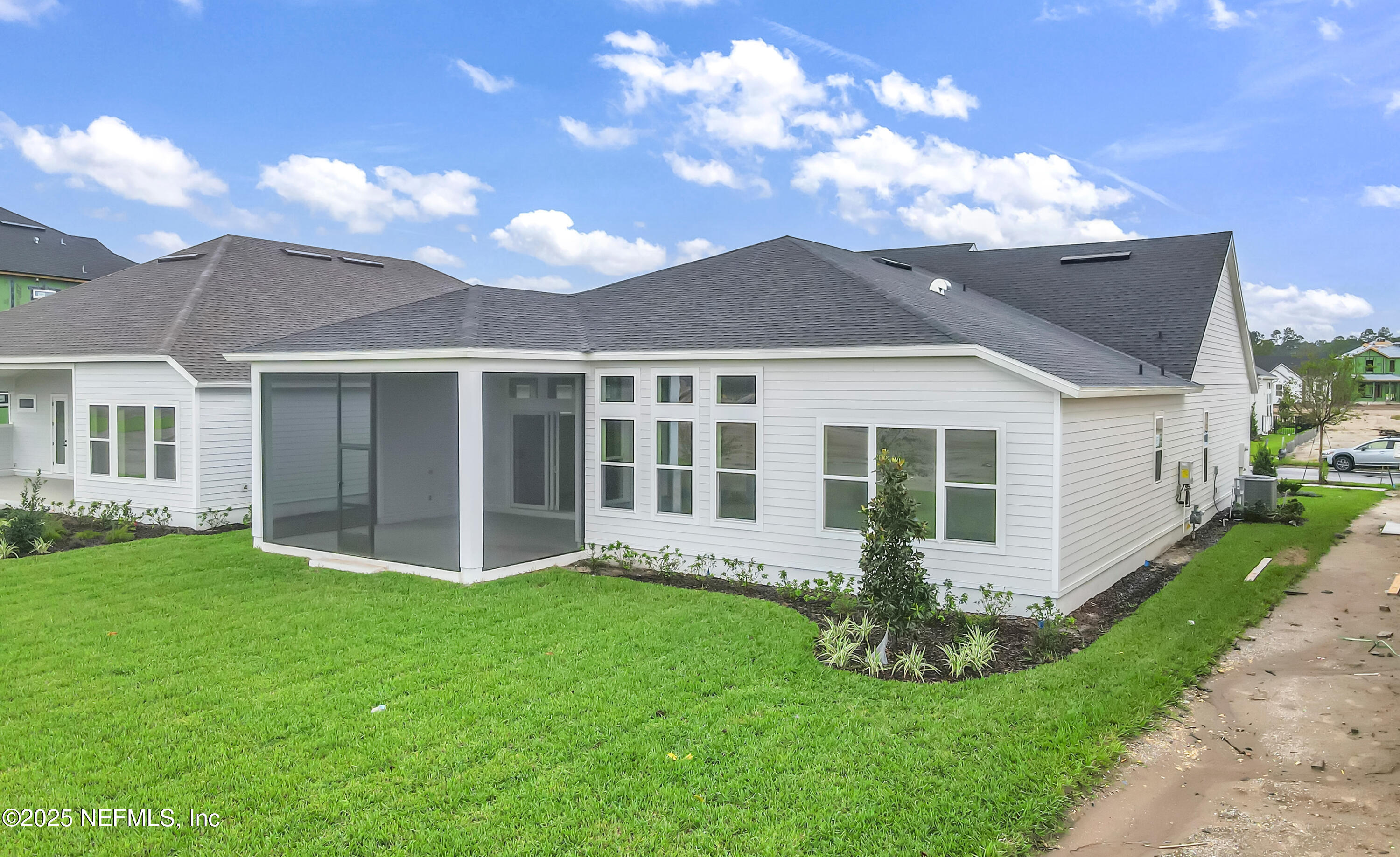 5541 Rainbarrel Road Jacksonville, FL 32224 - Photo 4 of 23 a front view of a house with a garden and yard