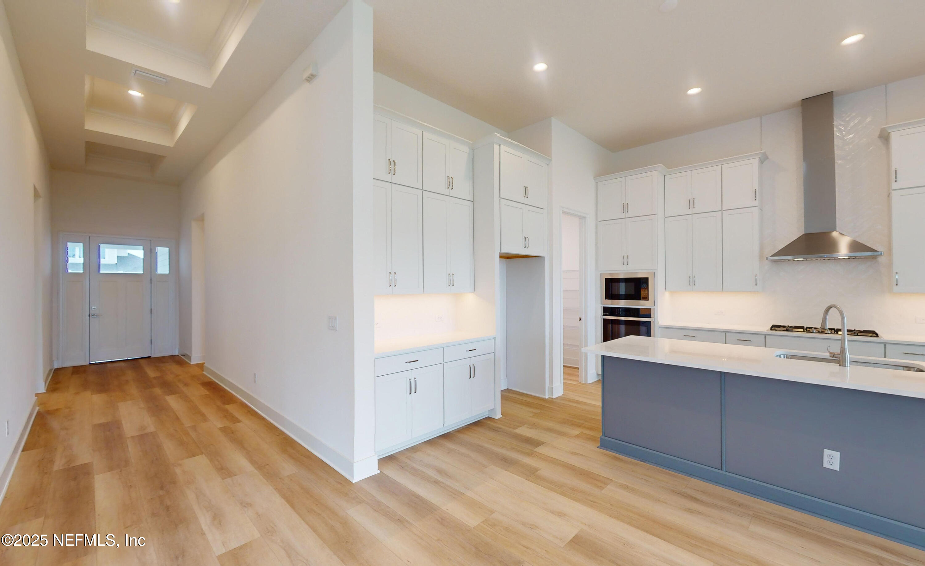 5541 Rainbarrel Road Jacksonville, FL 32224 - Photo 5 of 23 a kitchen with cabinets and wooden floor