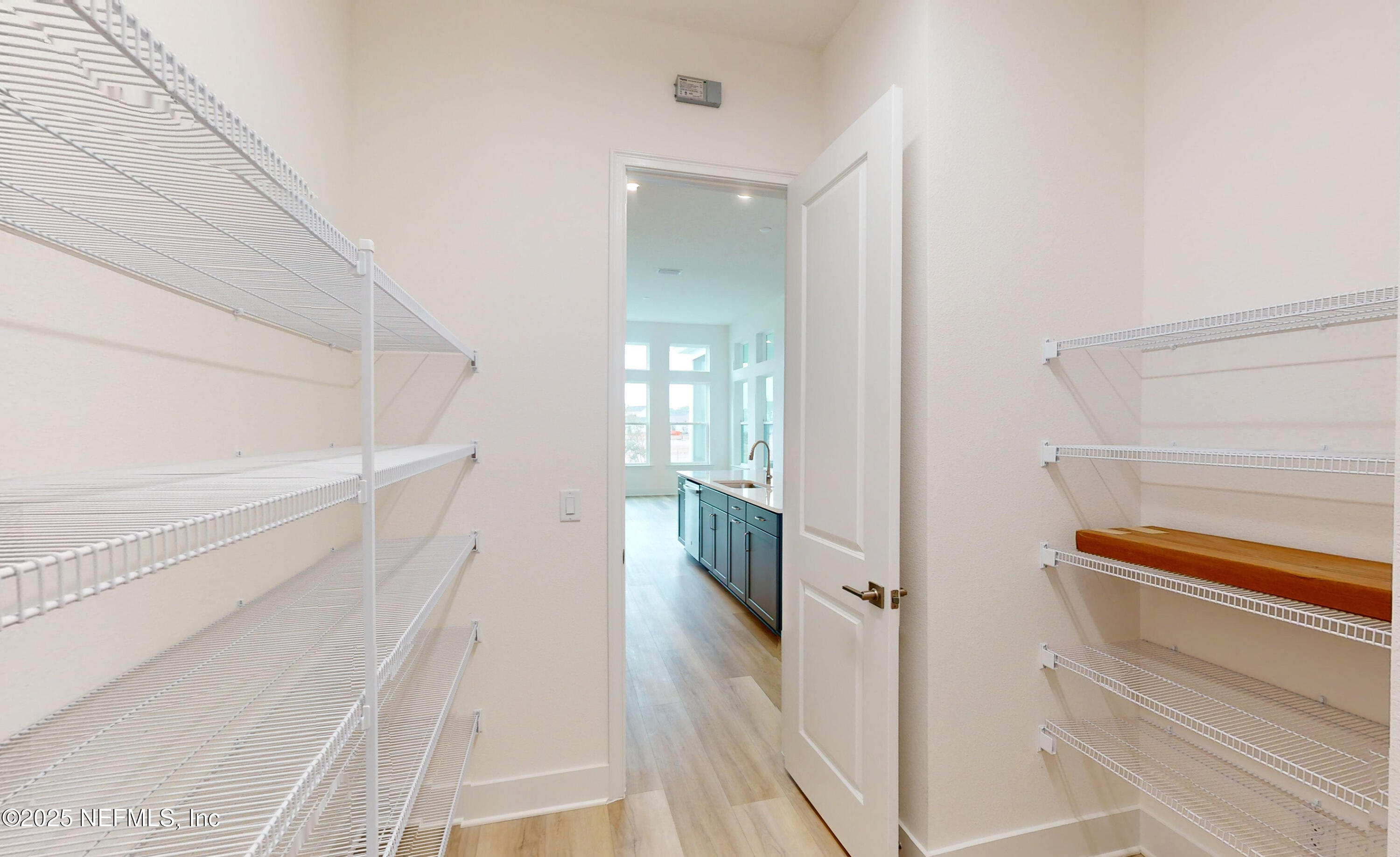 5541 Rainbarrel Road Jacksonville, FL 32224 - Photo 9 of 23 a view of a hallway with wooden floor and staircase