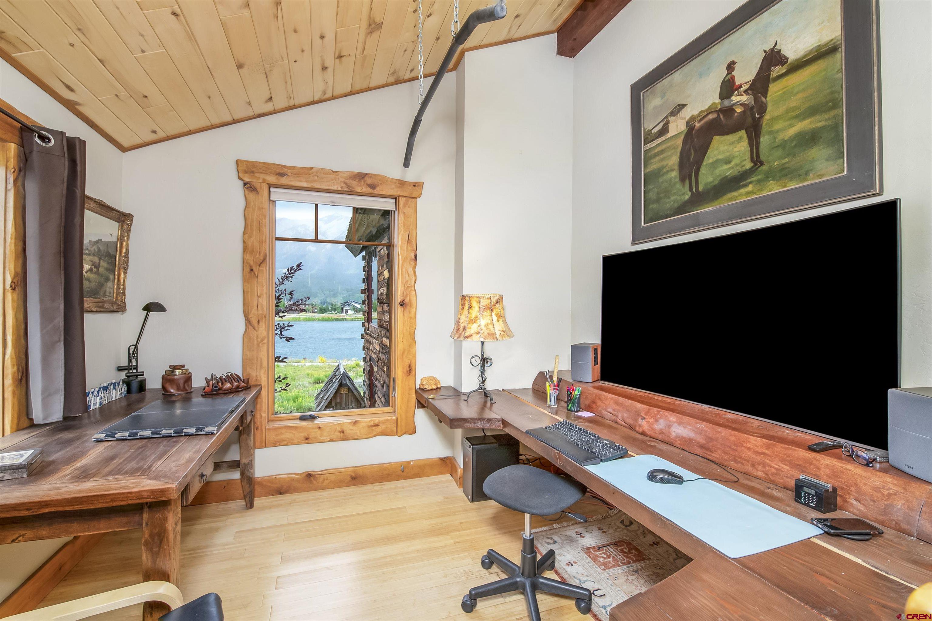 a living room with furniture flat screen tv and a large window