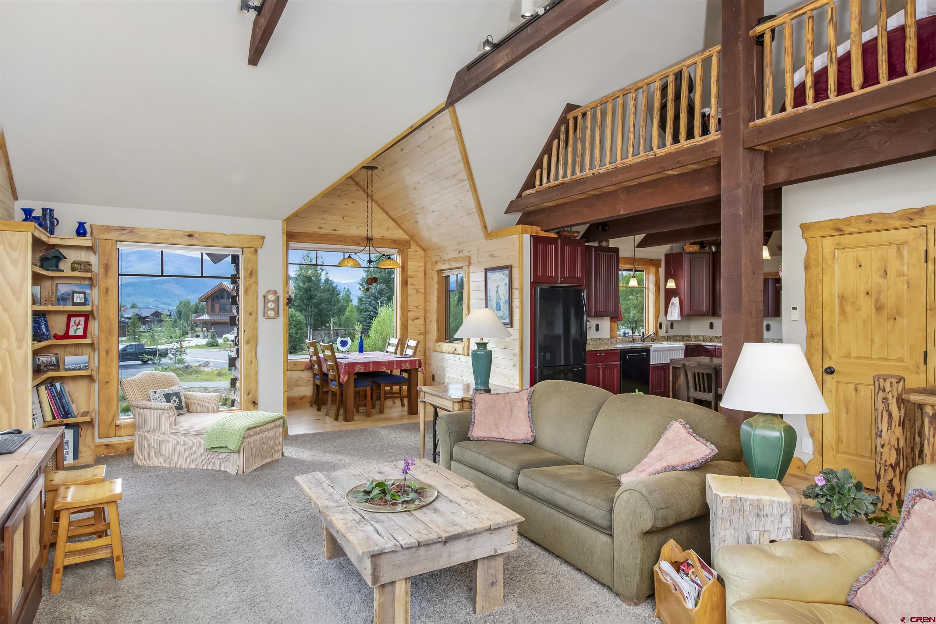 262 Larkspur Loop Crested Butte, CO 81224 - Photo 12 of 45 a living room with furniture a fireplace and large windows