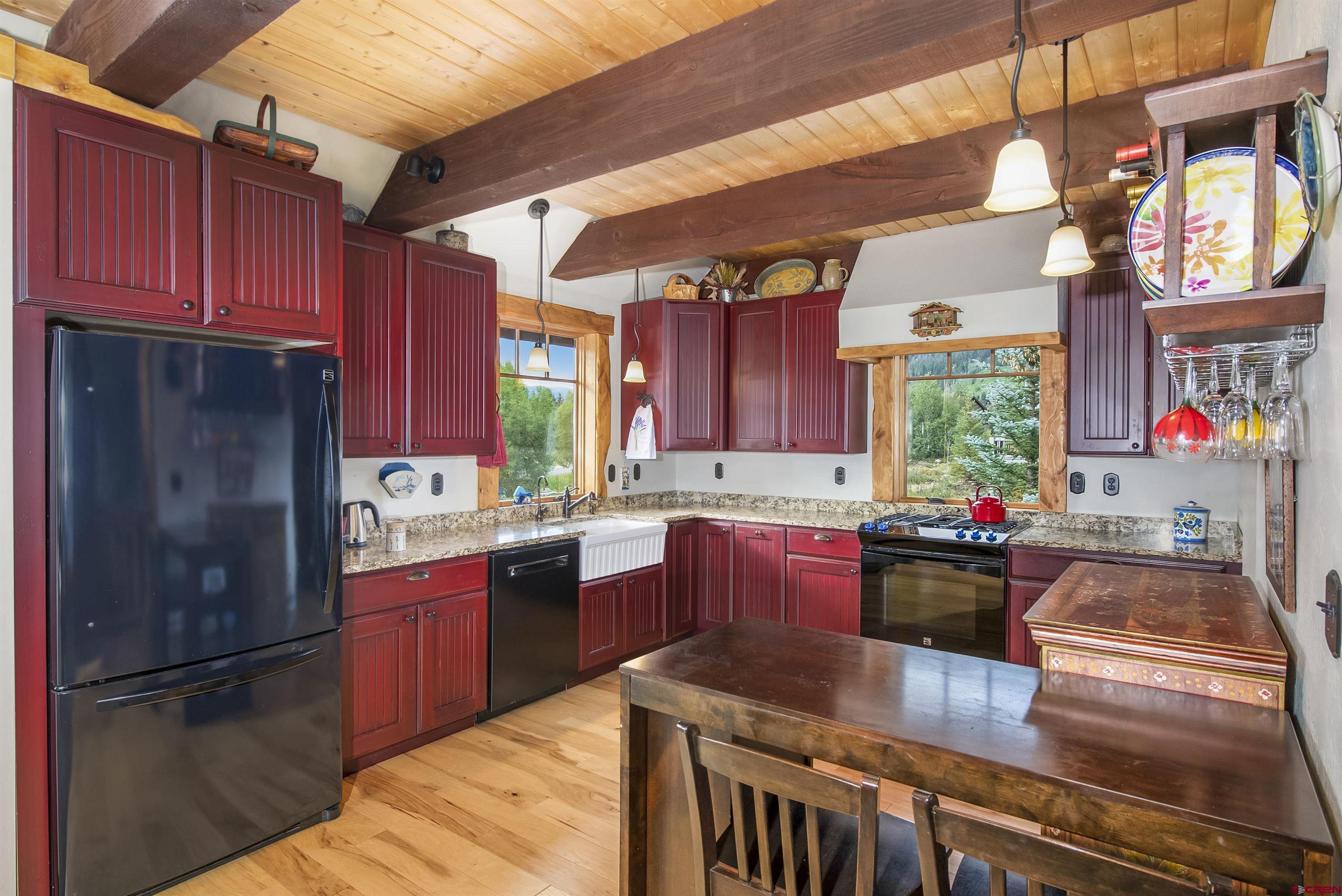 262 Larkspur Loop Crested Butte, CO 81224 - Photo 15 of 45 a kitchen with stainless steel appliances granite countertop a sink stove and refrigerator