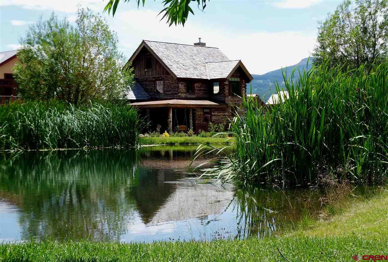 262 Larkspur Loop Crested Butte, CO 81224 - Photo 45 of 45 a view of a lake with a house in the background and lake view