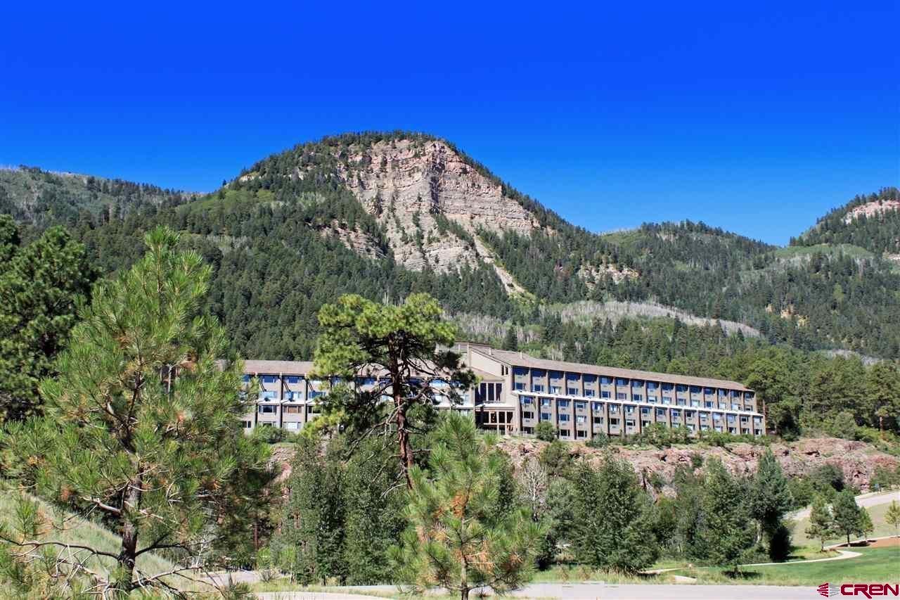 a view of a large building with a mountain in the background