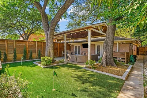 a view of house with backyard