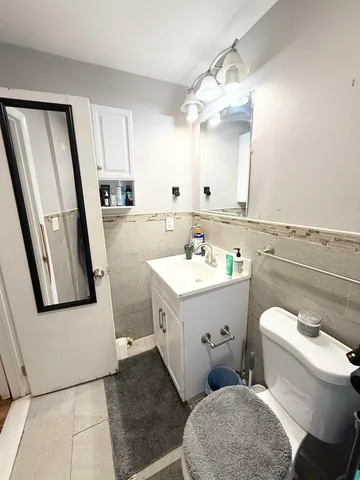 a bathroom with a sink toilet and mirror