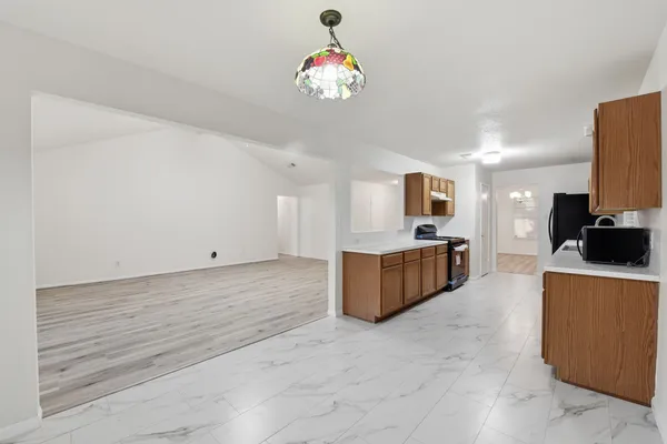 a large white kitchen with cabinets