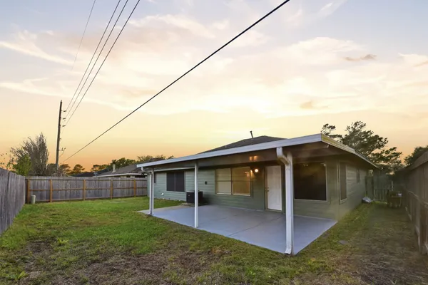 a view of a house with a yard and deck