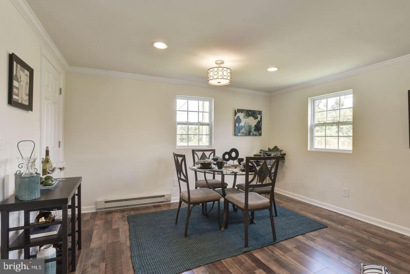 2440 Millers Mill Road Glenwood, MD 21738 - Photo 13 of 25 a view of a dining room with furniture and wooden floor