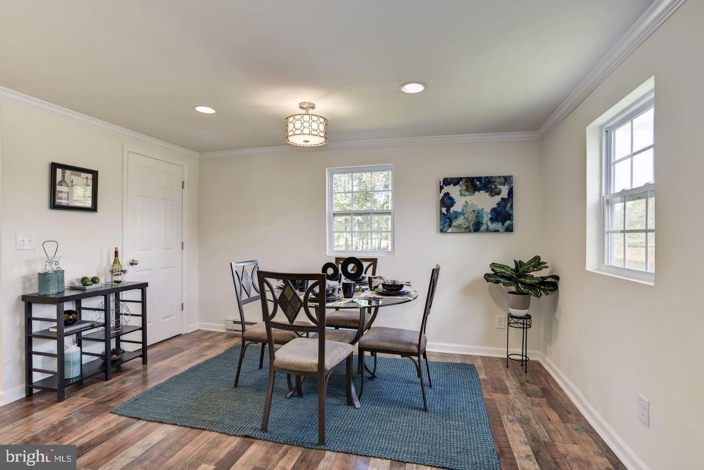 2440 Millers Mill Road Glenwood, MD 21738 - Photo 14 of 25 a view of a dining room with furniture and wooden floor