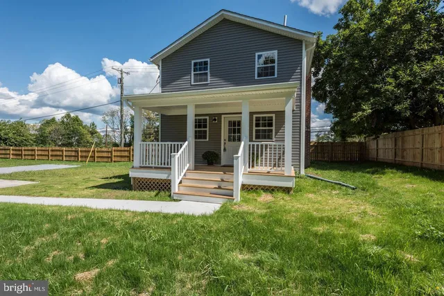 a front view of a house with a yard table and chairs
