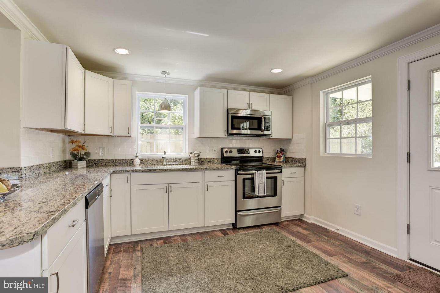 2440 Millers Mill Road Glenwood, MD 21738 - Photo 9 of 25 a kitchen with sink a microwave and cabinets